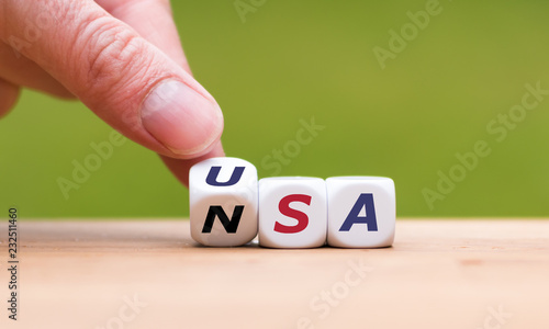 Obraz na plátně Hand is turning a dice and changes the word NSA to USA