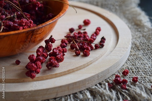 Useful Chinese lemongrass.Dried berry in a plate on a wooden background.
