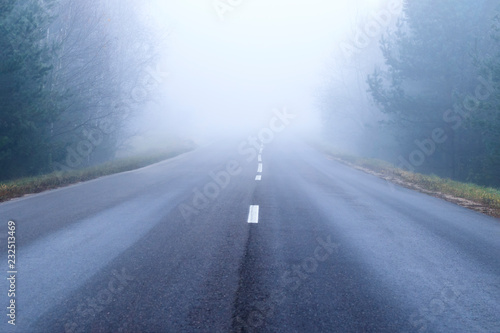 road markings and lines. Mist covers part of the road. traveling far for long distances. Highway in a natural landscape. there is tonirovka, soft light