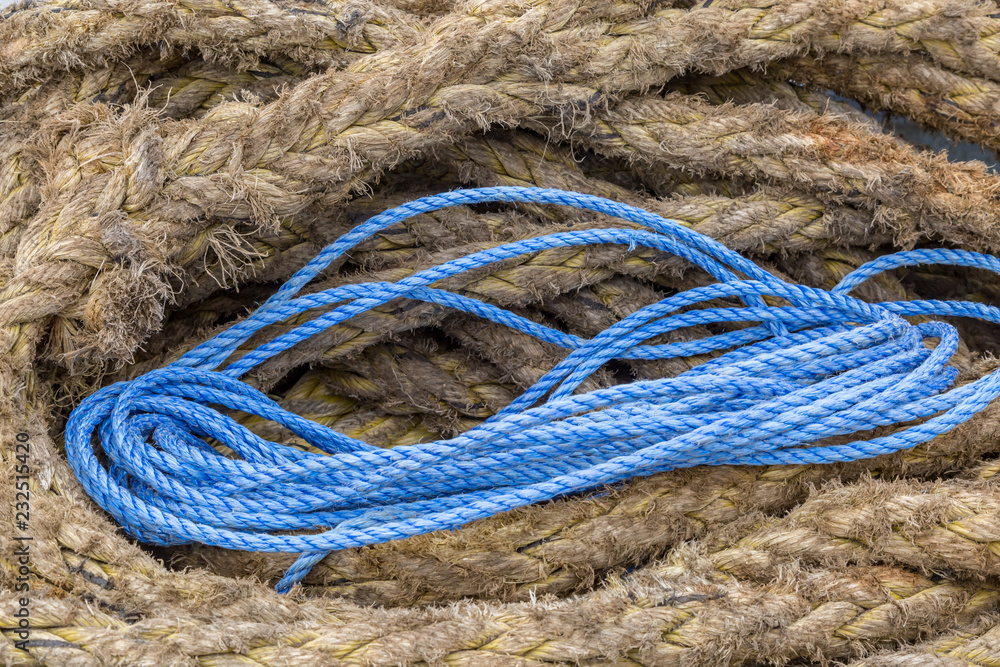 A full frame photograph of different sized and coloured rope on a ferry