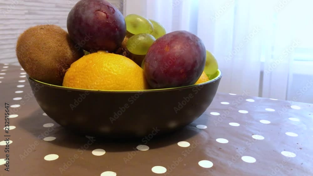 fruit in a plate on the table. drops of water on the fruit. 5 fruit in a plate on the table. drops of water on the fruit. 5
