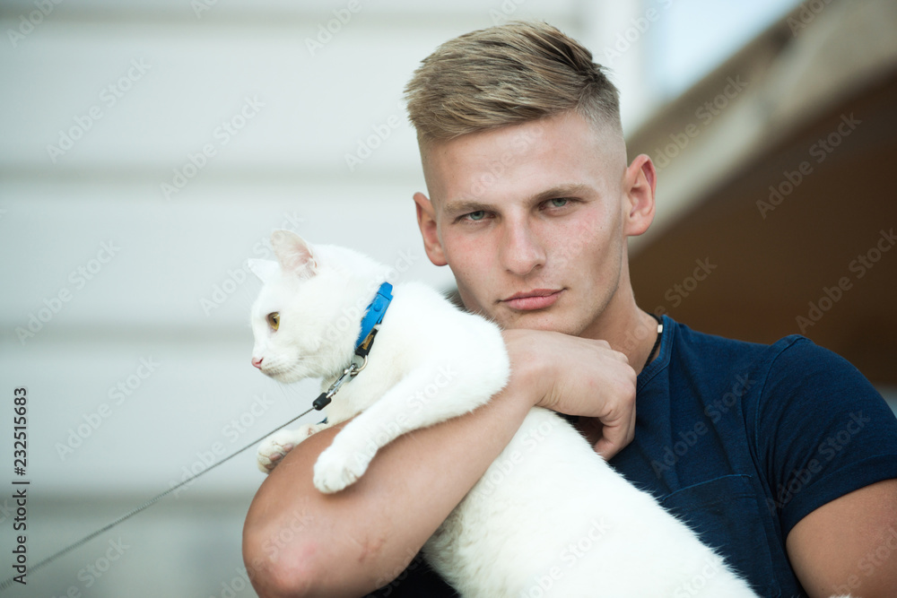 Me and my cat. Cat relaxes in arms of his owner. Happy man on walk with cat pet. Muscular man hold cute pedigree cat. Happy cat owner with muscular look Me and my cat. Cat relaxes in arms of his owner. Happy man on walk with cat pet. Muscular man hold cute pedigree cat. Happy cat owner with muscular look