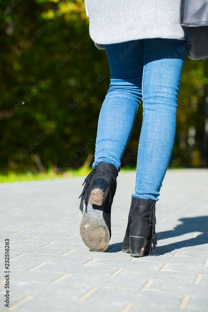 dirty shoe sole. autumn slush. Close up of woman's boots while hiking on  trail in the mountains. demi-season shoes. beautiful girl legs. autumn  park. gray pavement Stock Photo | Adobe Stock
