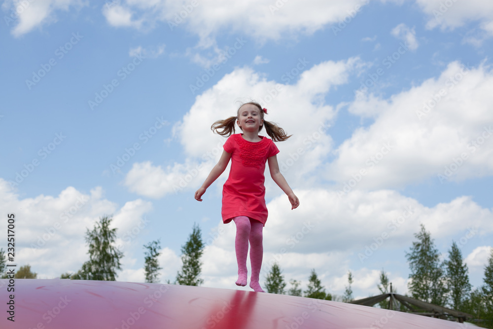 beautiful little girl jumping on a trampoline beautiful little girl jumping on a trampoline