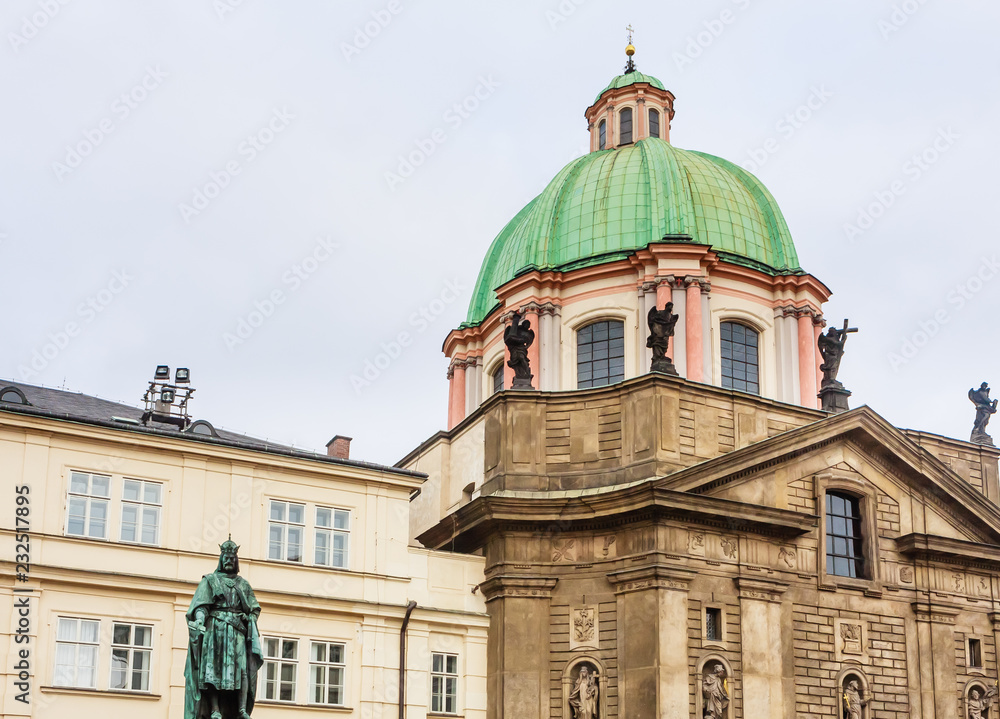  Statue of Emperor Charles IV  and Catholic church of St. Francis of Assisi. Prague, Czech Republic