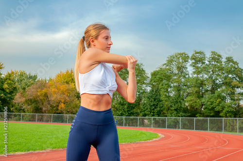 Fitness woman warming up exercises. Girl doing stretching her arms © Dmytro Flisak