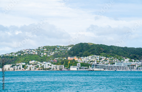 View across Wellington harbour to homes and buildings on side of Mount Victoria