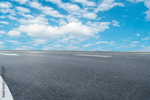 Empty highway asphalt pavement and sky cloud landscape.. © 昊 周