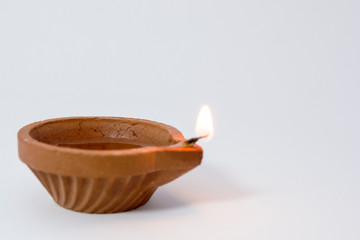 Closeup of Diwali terracotta diyas on Isolated white background.