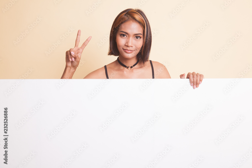 Young Asian woman show victory sign with blank sign. Young Asian woman show victory sign with blank sign.