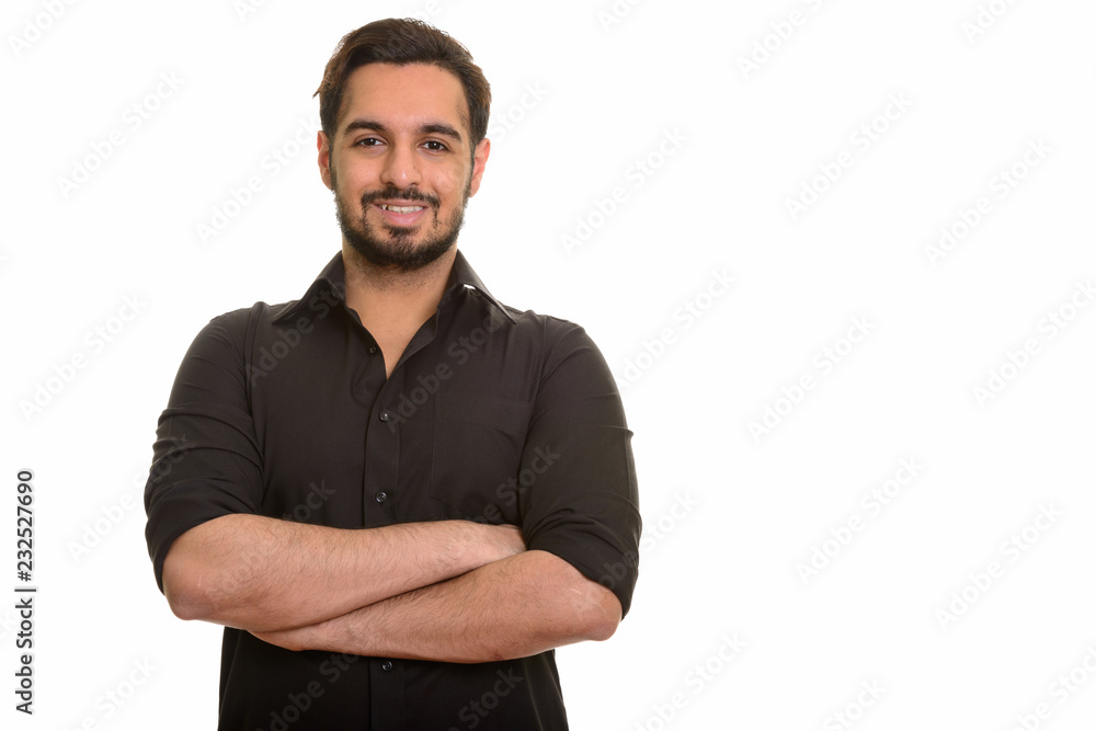 Young happy Indian man smiling with arms crossed Young happy Indian man smiling with arms crossed