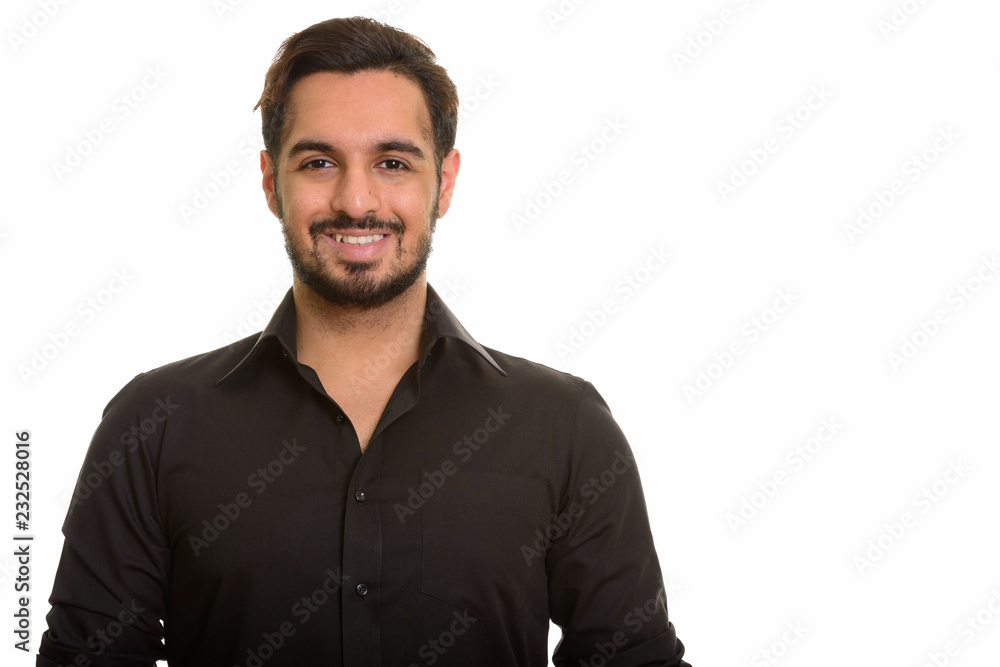 Young happy Indian man smiling and looking at camera Young happy Indian man smiling and looking at camera