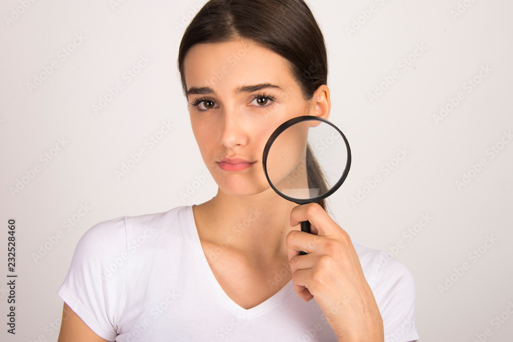 Young girl unhappy with having skin problems. holding magnifier face skin close up Young girl unhappy with having skin problems. holding magnifier face skin close up