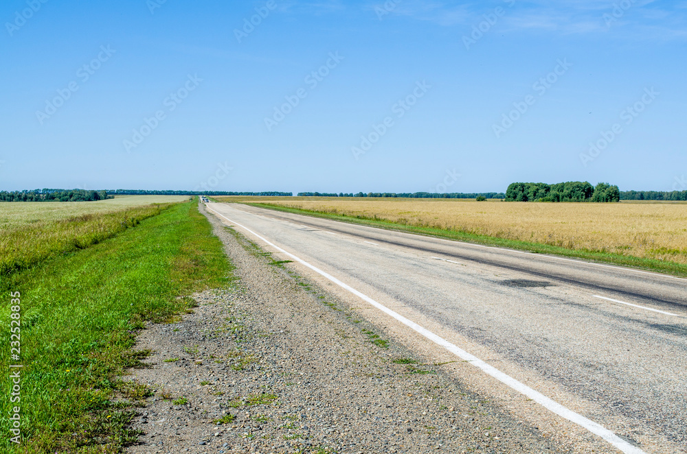 the road among spacious fields