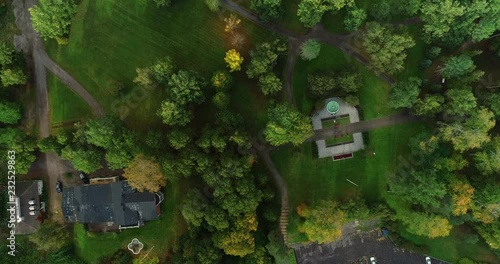 Flying above a park with trees and grass with a some streets and traffic in Forssa Finland photo