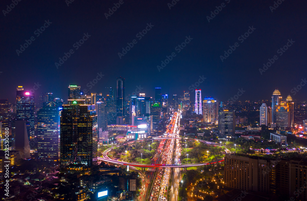 Jakarta city with glowing lights in hectic traffic