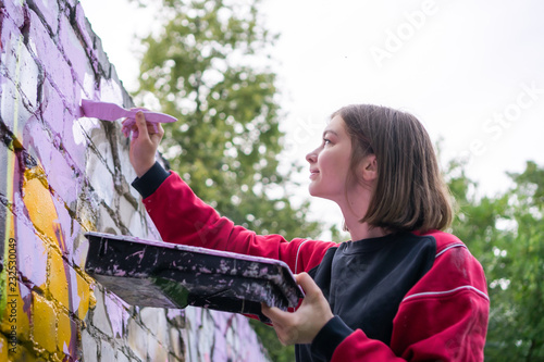 Street Artist Making a New Graffiti. photo