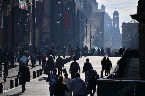 Visitors of the historical part of Mexico-City.  People in the shopping zone of Mexico-City on a warm and sunny day.