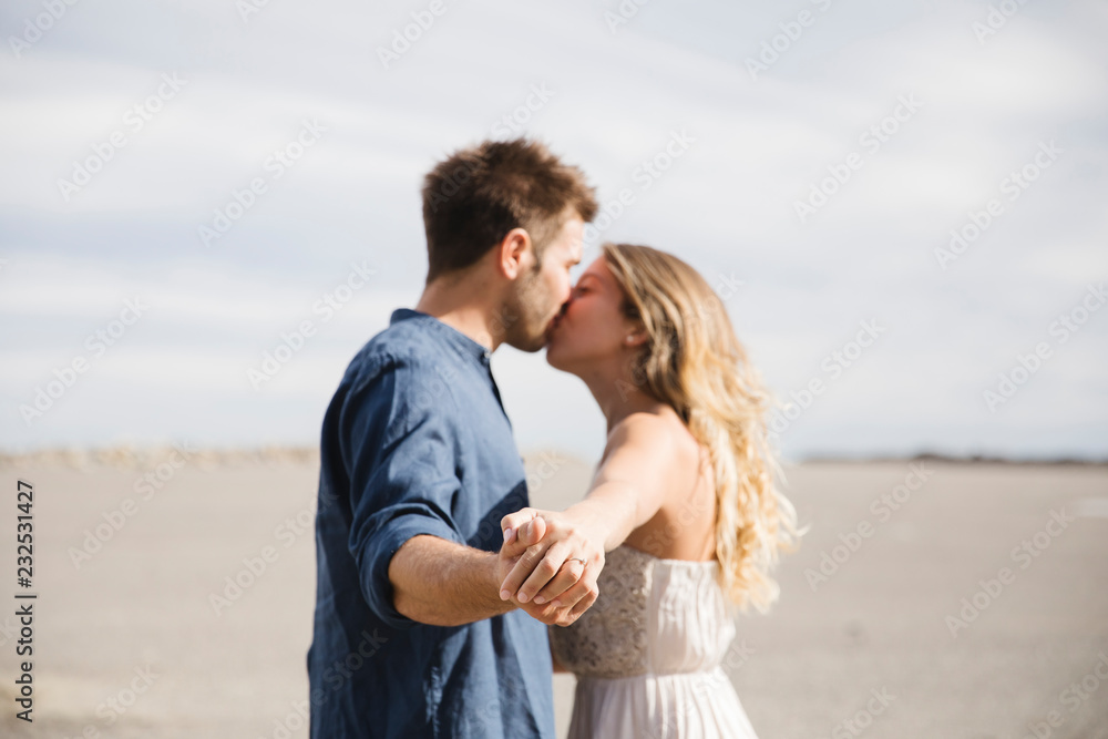 Couple of lovers kissing in an open space