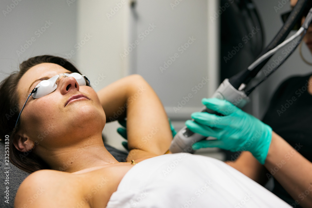 Spa: Female Patient Undergoing Laser Hair Removal Treatment Spa: Female Patient Undergoing Laser Hair Removal Treatment