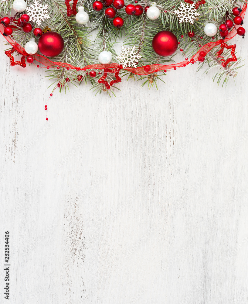 Fir branch with Christmas decorations on old wooden shabby background with empty space for text. Top view.