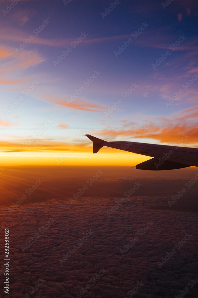 Sunrise out the window of an airplane Sunrise out the window of an airplane