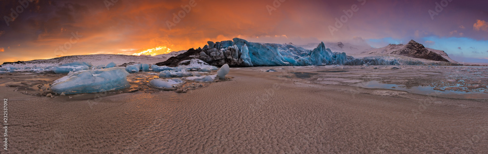 Famous Fjallsarlon glacier and lagoon with icebergs swimming on frozen water. Famous Fjallsarlon glacier and lagoon with icebergs swimming on frozen water.