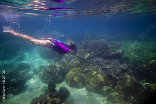 Woman swimming in water, Beautiful woman under water before dive to coral reef, woman snorkeling in blue mask, snorkel woman face in mask, tropical sea snorkeling, summer vacation activity
