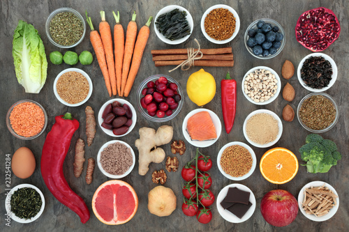 Billede på lærred Super food to slow the ageing process concept with fish, fruit, vegetables, seeds, nuts, herbs, spices, supplement powders, green and black teas, high in antioxidants, dietary fibre and vitamins