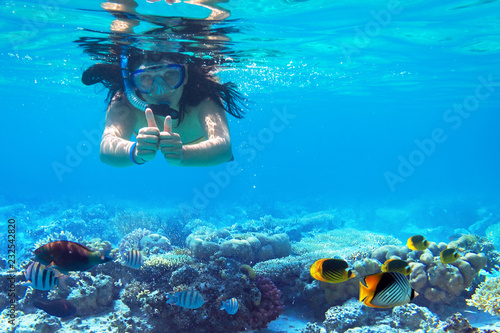 Woman at snorkeling in turquise sea water
