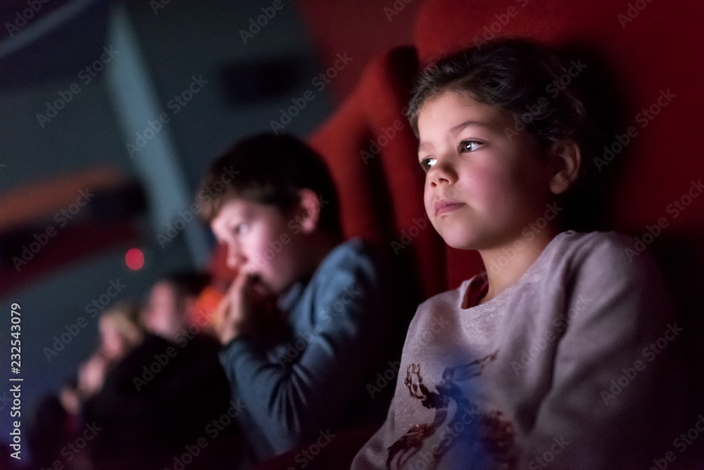 Children watching a movie in a movie theatre Children watching a movie in a movie theatre