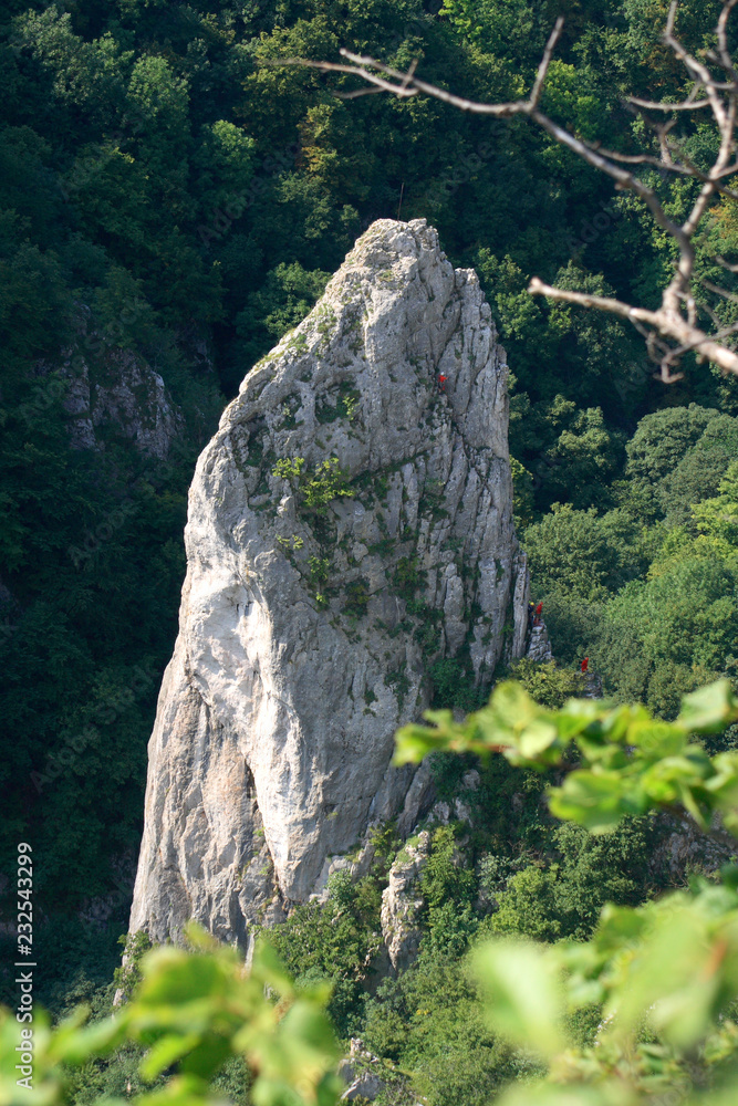 Climbers on the rock of Cukrova homola, Zadielska Valley, Slovak Karst, Slovakia