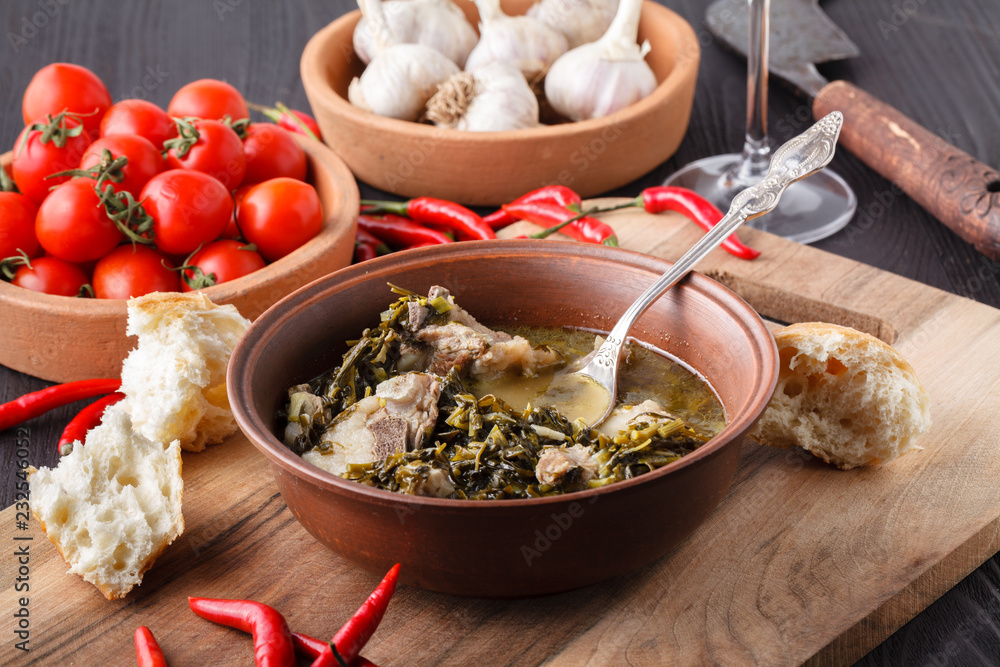 Chakapuli - Georgian stew.made from lamb chops or veal, onions, tarragon leaves, cherry plums or tkemali Chakapuli - Georgian stew.made from lamb chops or veal, onions, tarragon leaves, cherry plums or tkemali