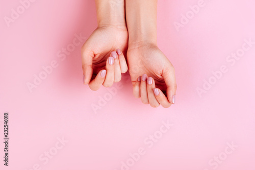 Stylish trendly pink manicure on a pink background