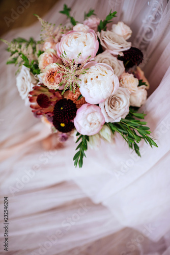 wedding bouquet with rose bush  Ranunculus asiaticus as a background