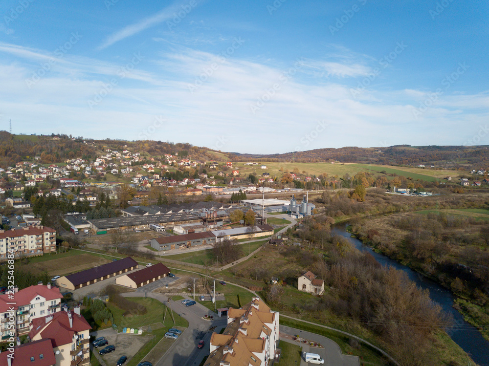 Strzyzow, Poland - 9 9 2018: View of the factory and residential area for workers with low multi-storey houses. Panorama from the drone or quadrocopter with a bird's-eye view. Architectural layout of Strzyzow, Poland - 9 9 2018: View of the factory and residential area for workers with low multi-storey houses. Panorama from the drone or quadrocopter with a bird's-eye view. Architectural layout of