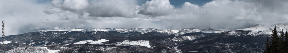 Mist rises as dramatic snowstorm moves across mountain valley Mist rises as dramatic snowstorm moves across mountain valley