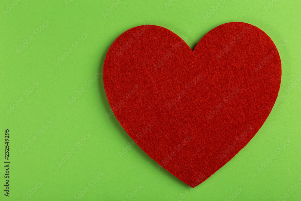 Red felt heart on bright green background. St. Valentine's day Red felt heart on bright green background. St. Valentine's day