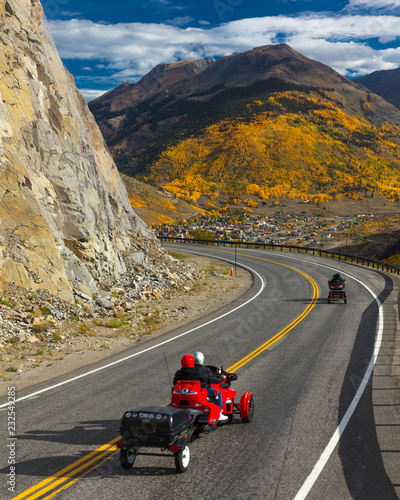 Motorcycles drive autumn road goes from Ouray to Silverton Colorado, the "Million Dollar Highway" with color, Route 550