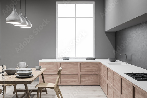 Gray kitchen with table, side view