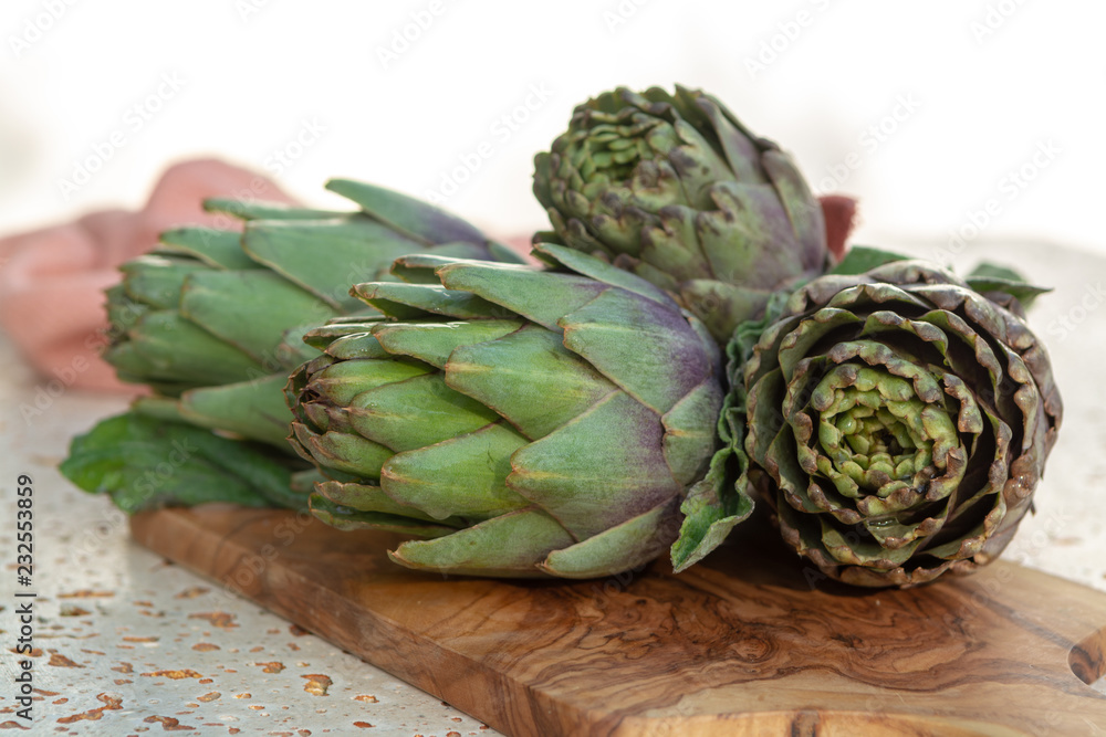 Obraz premium Traditional Italian food, fresh green artichoke vegetables, new harvest, uncooked
