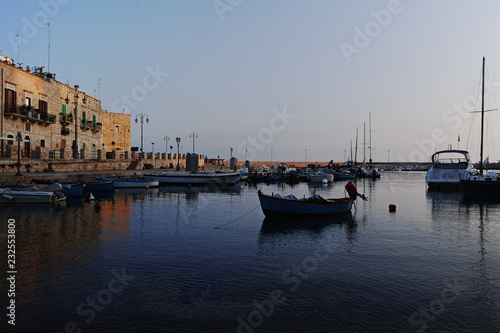Old fishing harbor with colorful wooden boats in old small city Giovinazzo near Bari, Apulia, Italy in early morning © barmalini