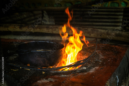 Open cooking place with fire and a kettle for deep frying