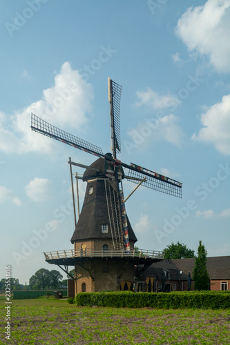 Traditional old Dutch grain wind mill, Dutch countryside landscape
