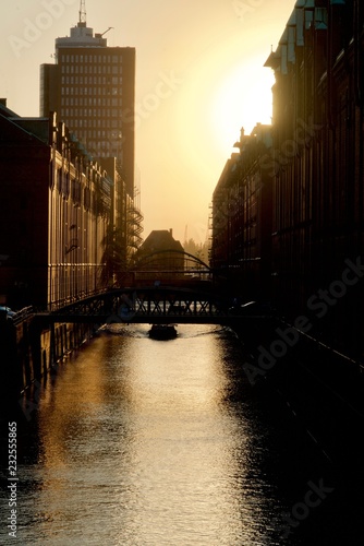 Boat under a bridge of the Speicherstadt photo