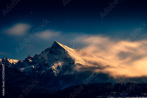 Night time landscape view of mountain peak Krivan with moonlight, High Tatras, Slovakia