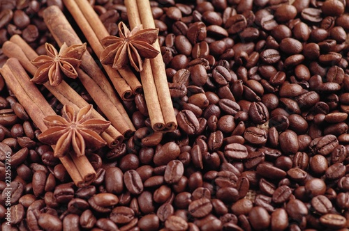 Aromatic roasted coffee beans and anis or badian, sticks of natural cinnamon on background close up