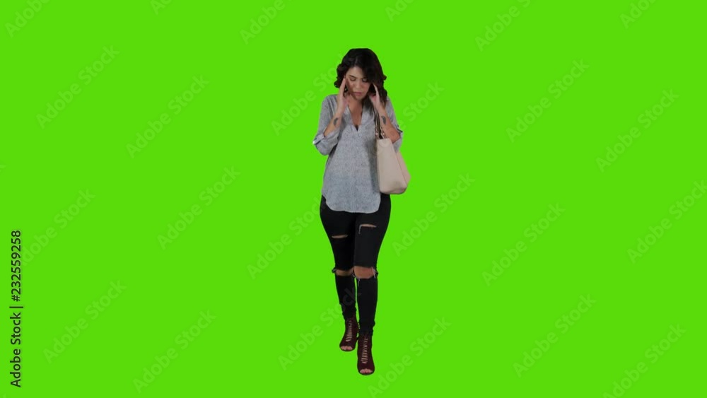 Sad and ill woman walking upset over a green screen. full frontal body shot over a green screen, casual look. Sad and ill woman walking upset over a green screen. full frontal body shot over a green screen, casual look.