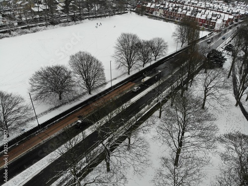 Road with snow covered field either side of it on a snowy day, taken in Kirkstall Leeds West Yorkshire.