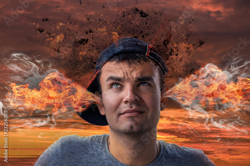 Conceptual image of a tense young man with smoke coming out of his ears and his head exploding.